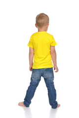 Rear view of caucasian full body american baby boy kid in yellow