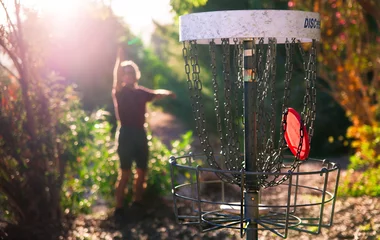 Fotobehang Golf Midway disk golf throw.   © derikmsmith