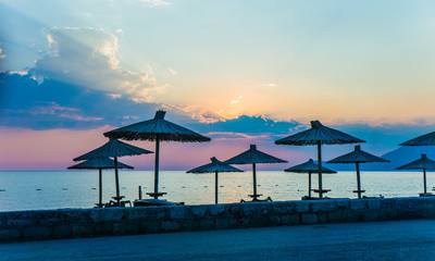 Parasol on the beach at sunset