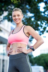 Fototapeta premium Portrait of a beautiful athlete with her hands on her hips