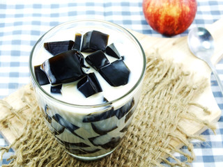 milk tea with black jelly in clear glass on white background
