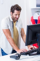 Smiling cashier typing