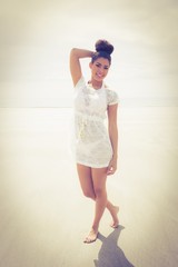 Stylish girl posing on the sand