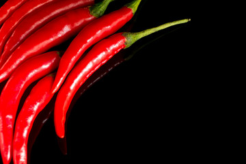 Red chili pepper isolated on black background