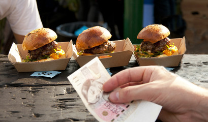 Buying burgers in czech crown at street kiosk