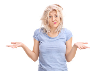 Confused blond girl with a messy hair gesturing with hands