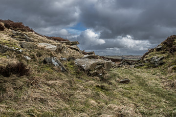 Dramatic landscape of the moors in Yorkshire, England with gloomy, stormy skies.