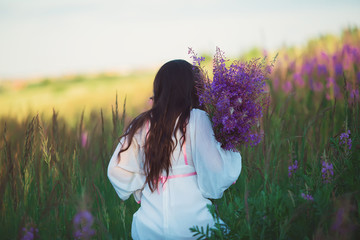 girl walking on the field to the field of lavender