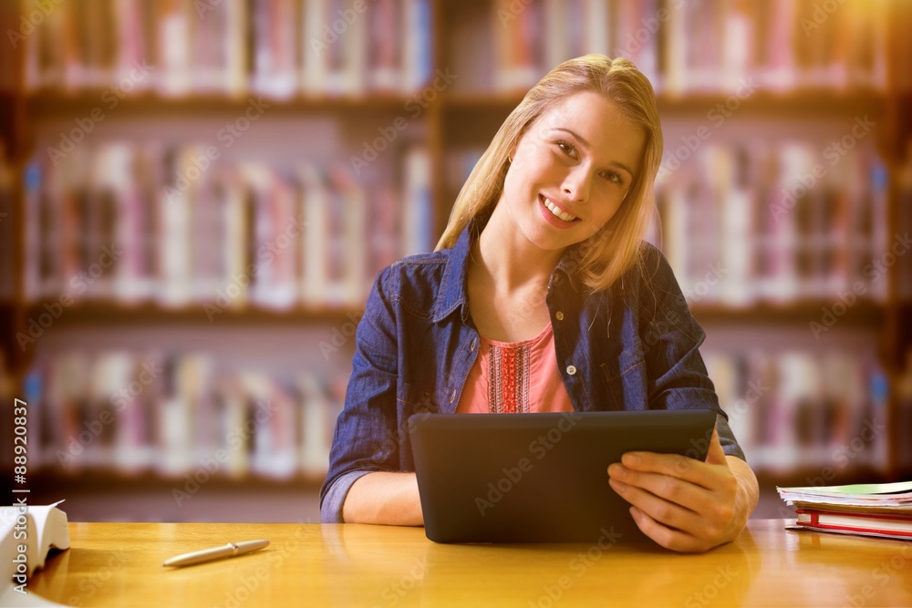 Poster composite image of student studying in the library with tablet