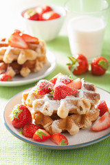 belgian waffles with icing sugar and strawberry