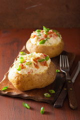 baked potato in jacket with bacon and cheese