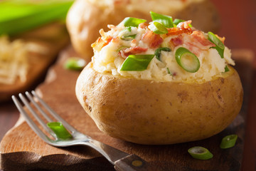 baked potato in jacket with bacon and cheese