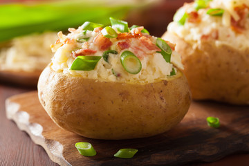 baked potato in jacket with bacon and cheese