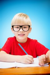 Composite image of cute pupils at desk