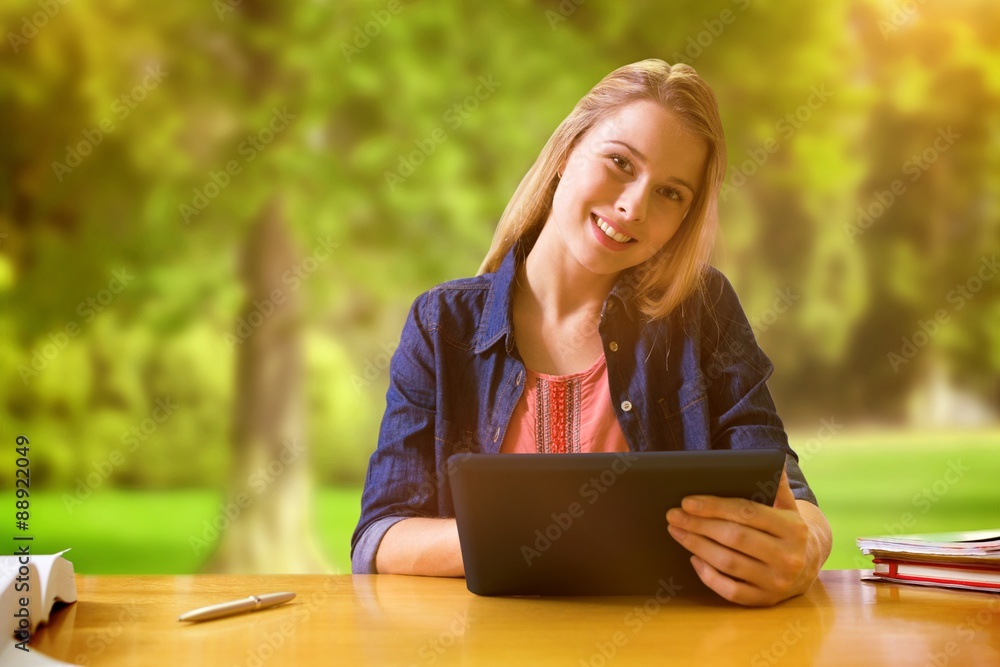 Poster Composite image of student studying in the library with tablet