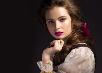 Beautiful Russian girl in national dress with a braid hairstyle and pink lips. Beauty face. Picture taken in the studio on a black background.
