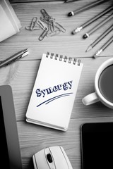 Synergy against notepad on desk