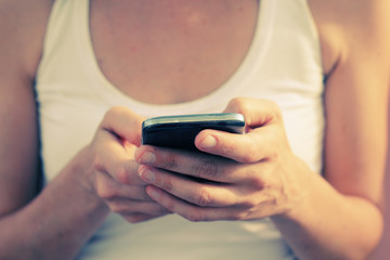 woman's hands with cellphone