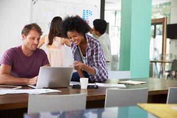 Four Businesspeople Having Creative Meeting In Office
