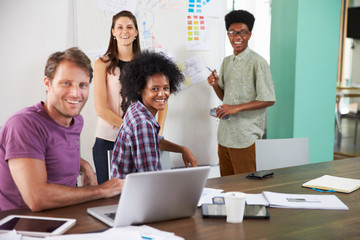 Portrait Of Businesspeople Having Creative Meeting In Office