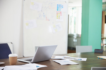 Businessman Sitting At Desk In Office Working On Laptop