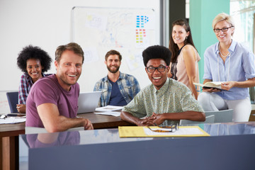 Portrait Of Businesspeople Having Creative Meeting In Office