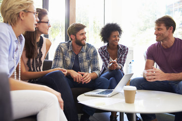 Businesspeople Having Informal Meeting In Modern Office