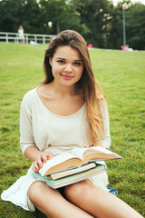 young caucasian female student with books on campus, student study in campus area