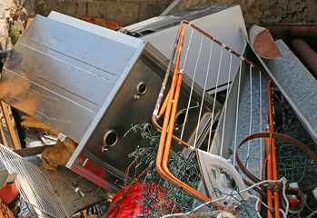 old clothes dryer and stove destroyed in ferrous waste dump