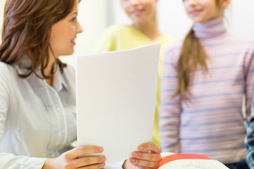 Fototapeta premium close up of school kids with teacher in classroom