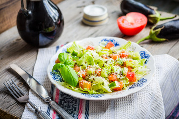Fresh vegetable salad with tomato, eggplant, sesame seeds and fl