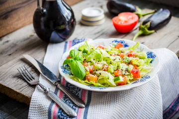 green vegetable salad with tomato, eggplant, sesame seeds and ba