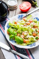 green vegetable salad with tomato, eggplant, sesame seeds and ba