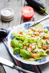 green vegetable salad with tomato, eggplant, sesame seeds and ba