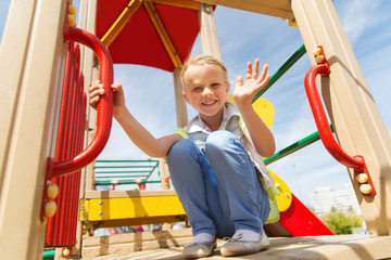 happy little girl climbing on children playground