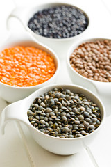 various lentils in ceramics bowls