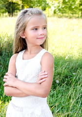 Portrait of smiling cute little girl in summer day