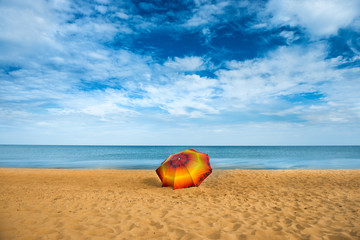 Fototapeta na wymiar Umbrella on golden sand beach