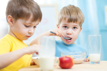 Obraz na płótnie Canvas kids eating healthy food at home or kindergarten