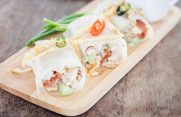 Fresh spring rolls on wooden table