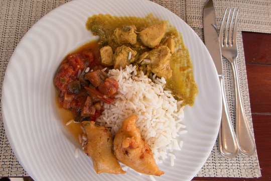 Chicken colombo, typical dish of the tradition in Guadeloupe, made with chicken legs and spices. Served with accras, appetizer made with fish.