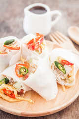 Fresh spring rolls on wooden table