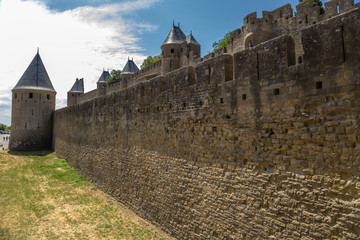 Fototapeta na wymiar Carcassonne, France. Double defensive walls of the fortress. Fortress of Carcassonne is included in the UNESCO World Heritage List