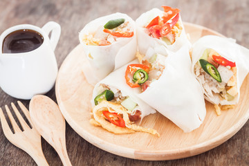 Fresh spring rolls on wooden table