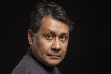 Fototapeta premium Studio portrait of a serious Hispanic male