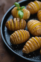Potatoes cut into slices almost right through and then baked