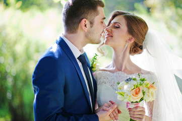 Close up portrait of kissing wedding couple