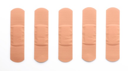Five adhesive bandages in a row