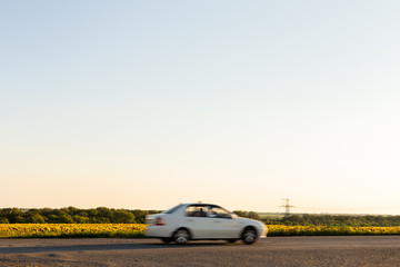 Fototapeta premium Blurred car next to field
