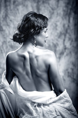 Fototapeta na wymiar Young girl posing studio black-and-white portrait vintage style